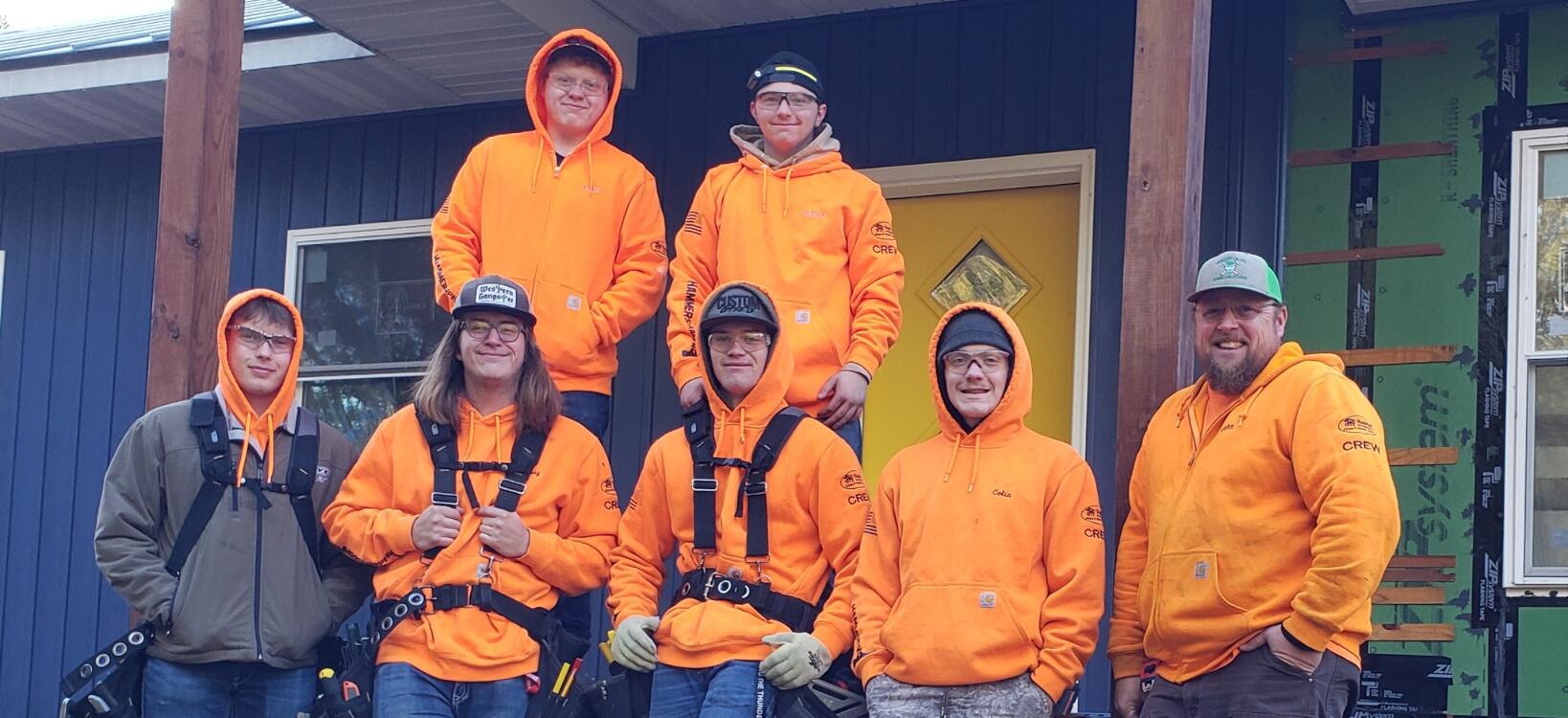 AFHS Advanced Construction Crew students in orange gear